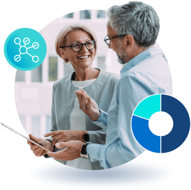 Two people smiling and talking while reviewing charts on a tablet